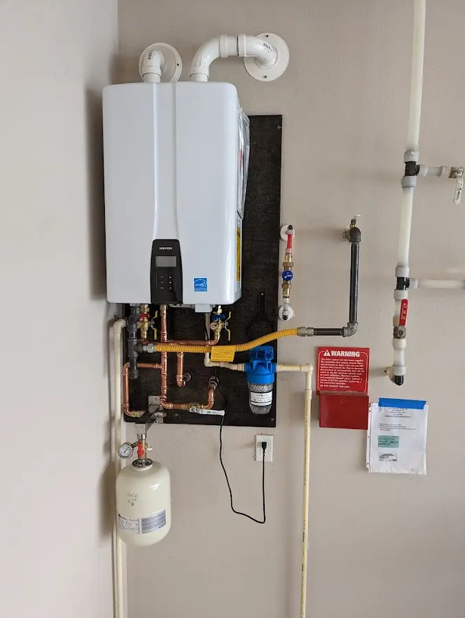 Professional plumber installing copper piping in a South Brunswick home